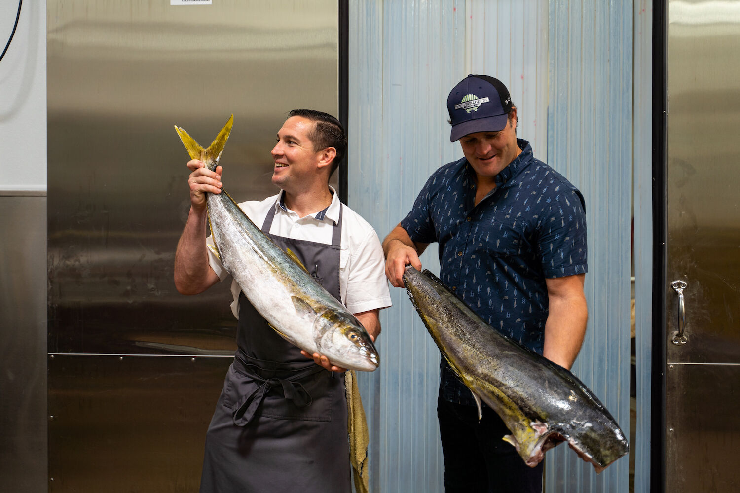 the fishery, men holding fish